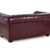 Classic Chesterfield 2 seater sofa in oxblood red bonded leather with button tufting, front angle