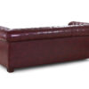 Rolled scroll arm detail with studded trim in oxblood red bonded leather on a Chesterfield 3 seater.