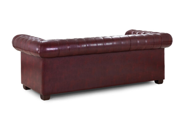 Rolled scroll arm detail with studded trim in oxblood red bonded leather on a Chesterfield 3 seater.