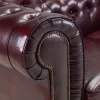 Full-length view of the timeless Chesterfield 3 seater sofa in rich oxblood red leather.