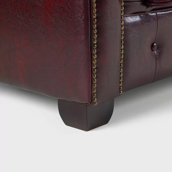 Sturdy wooden legs and solid frame of the Chesterfield 3 seater in oxblood red.